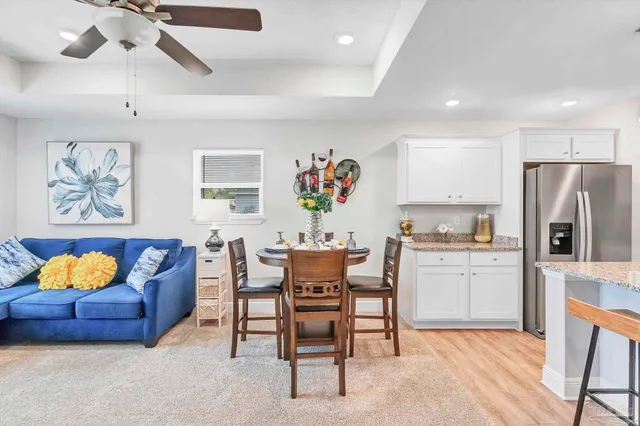 a kitchen with kitchen island a refrigerator a stove a sink and a oven with wooden floor