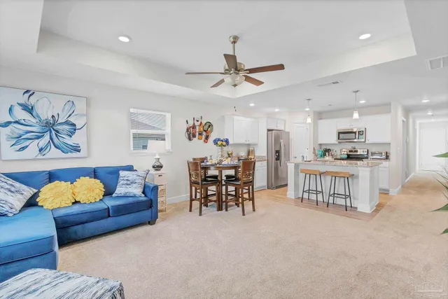 a view of a dining room with furniture and a potted plant