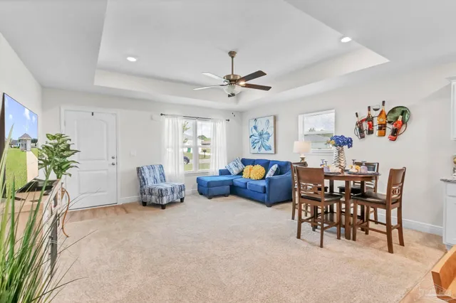 a living room with furniture and kitchen view
