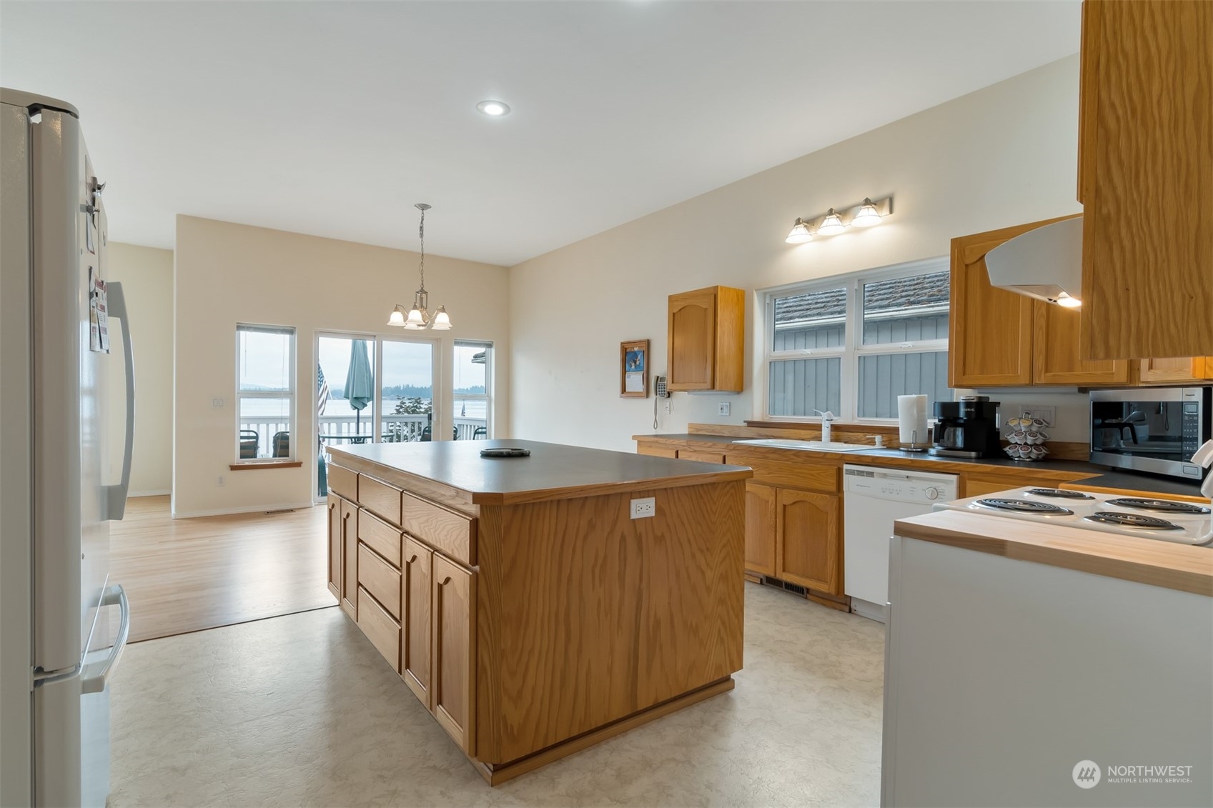 1811 Vernon Road Lake Stevens, WA 98258 - Photo 12 of 40 a kitchen with stainless steel appliances granite countertop a stove top oven a sink a refrigerator and white cabinets