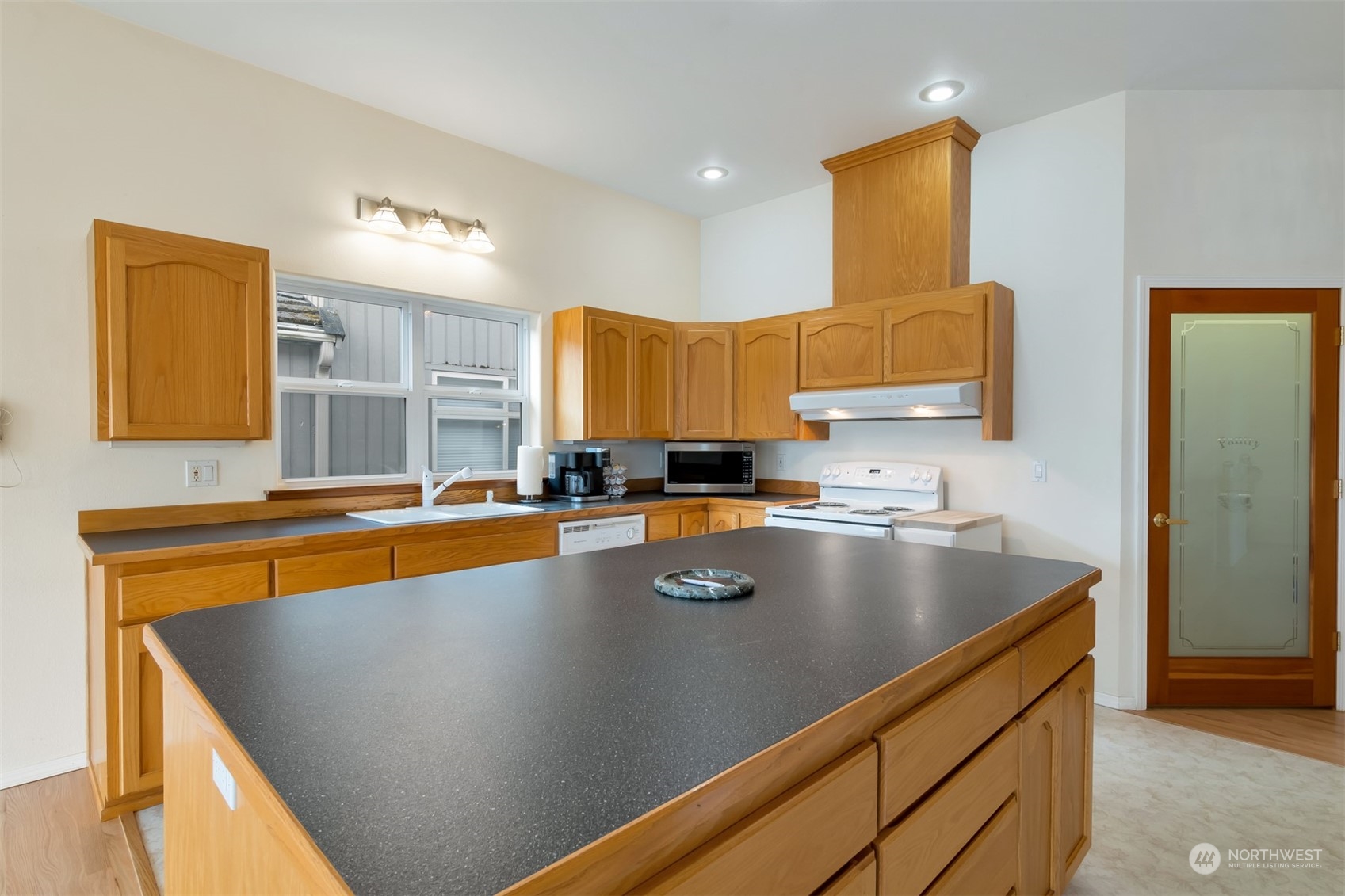 1811 Vernon Road Lake Stevens, WA 98258 - Photo 13 of 40 a view of a kitchen with stainless steel appliances granite countertop a sink a stove and a refrigerator