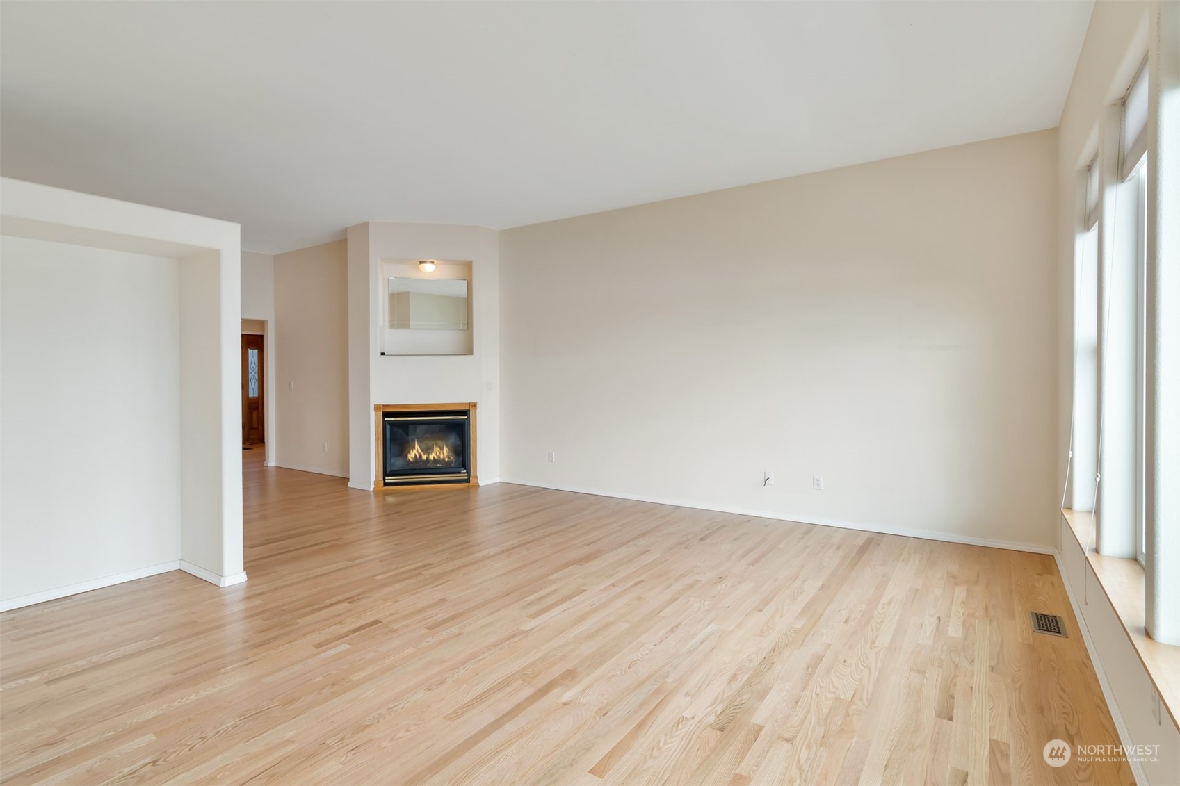 1811 Vernon Road Lake Stevens, WA 98258 - Photo 10 of 40 an empty room with wooden floor and fireplace