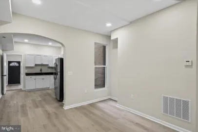 a view of kitchen with refrigerator and microwave