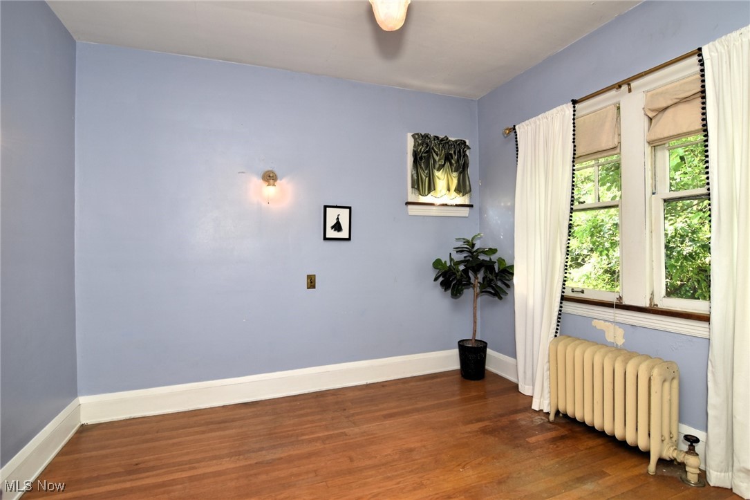17930 Rosecliff Road Cleveland, OH 44119 - Photo 32 of 50 Spare room with radiator and wood finished floors