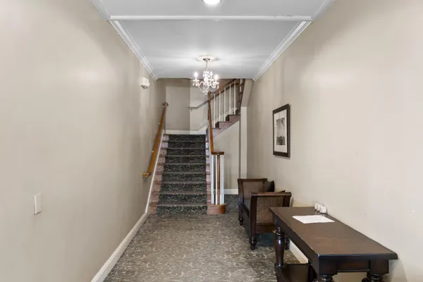 a view of a hallway with workspace and a window