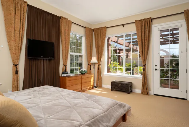 a bedroom with a bed and a television