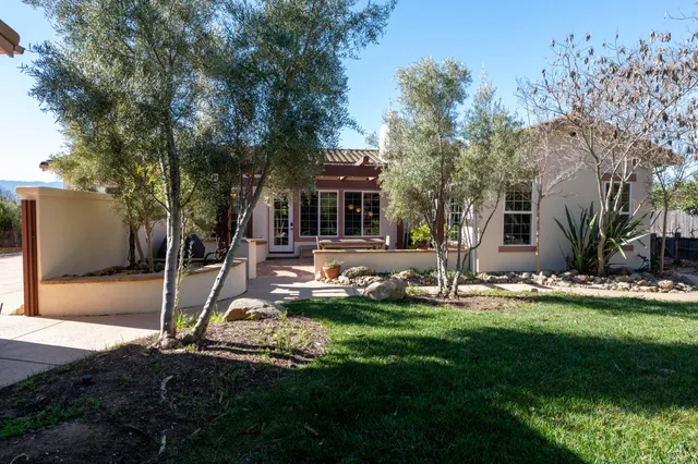 a house view with a sitting space and garden