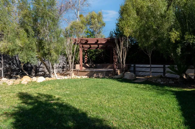 a view of a backyard with large trees