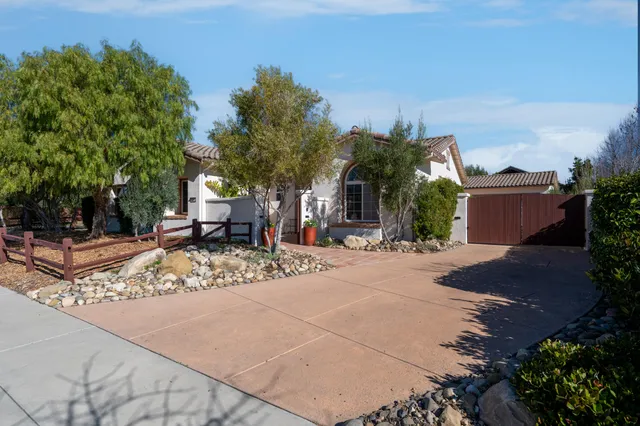 a view of a house with a yard and tree s