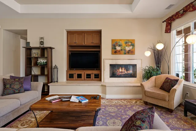 a living room with furniture and a fireplace