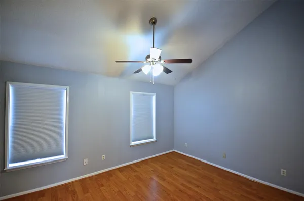 an empty room and chandelier fan