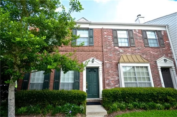 front view of a brick house with a large windows