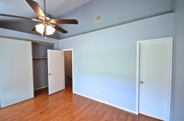 a view of an empty room with wooden floor