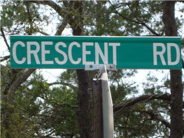 20 Crescent Road Santa Rosa Beach, FL 32459 - Photo 2 of 3 a sign that is on the side of a tree