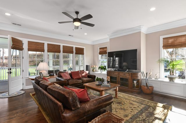 a living room with furniture and a book shelf