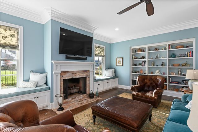 a dining room with furniture water view and wooden floor