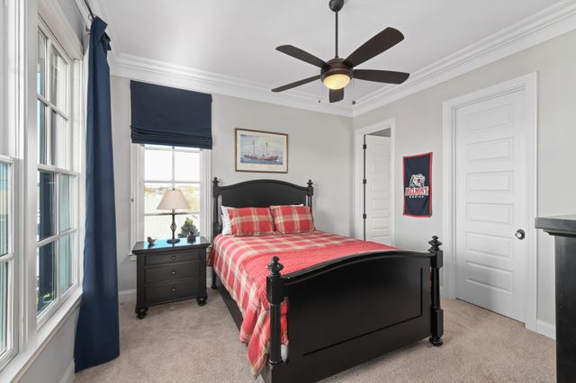 a bedroom with furniture and a flat screen tv