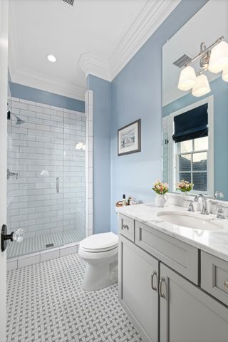 a bathroom with a double vanity sink toilet and shower