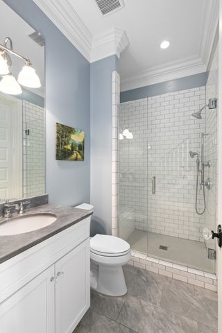 a bathroom with a granite countertop sink a toilet a mirror and bathtub