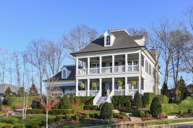 a view of a patio with table and chairs under an umbrella