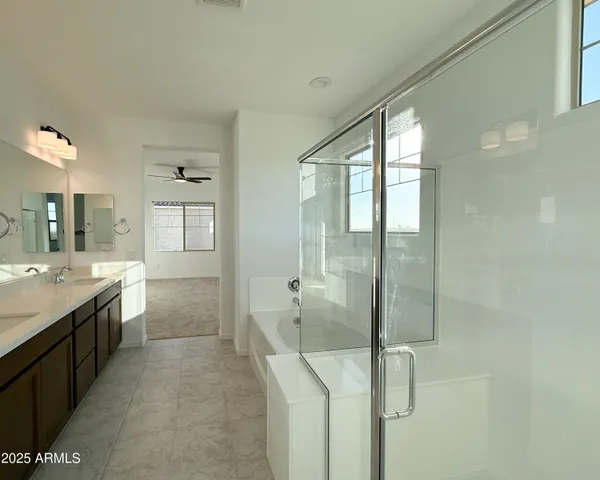 a bathroom with a double vanity sink toilet and shower