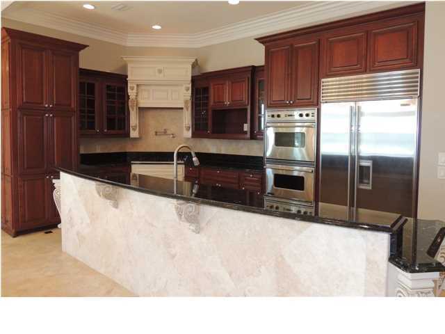 8708 Hwy Santa Rosa Beach, Unit B 30A Inlet Beach, FL 32461 - Photo 19 of 36 a kitchen with stainless steel appliances kitchen island granite countertop a refrigerator a stove and a sink with wooden cabinets