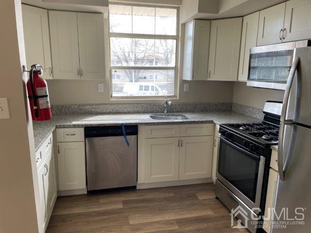 11 Florida Grove Road, Unit 5 Keasbey, NJ 08832 - Photo 7 of 12 a kitchen with stainless steel appliances granite countertop a stove and a sink