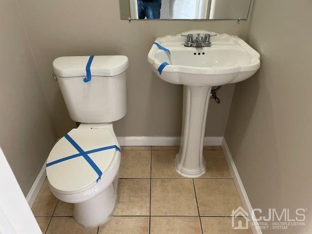 11 Florida Grove Road, Unit 5 Keasbey, NJ 08832 - Photo 10 of 12 a bathroom with a toilet sink and mirror