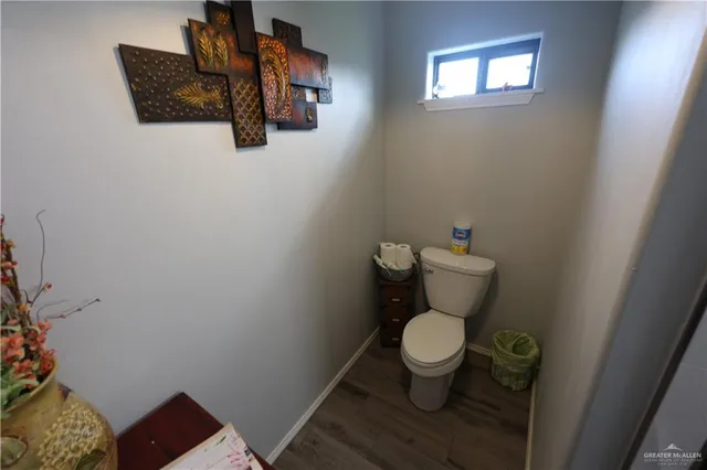a white toilet sitting in a bathroom