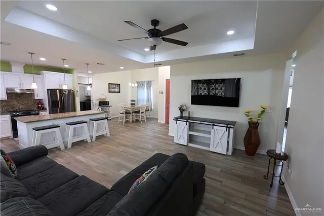 a living room with furniture and kitchen view