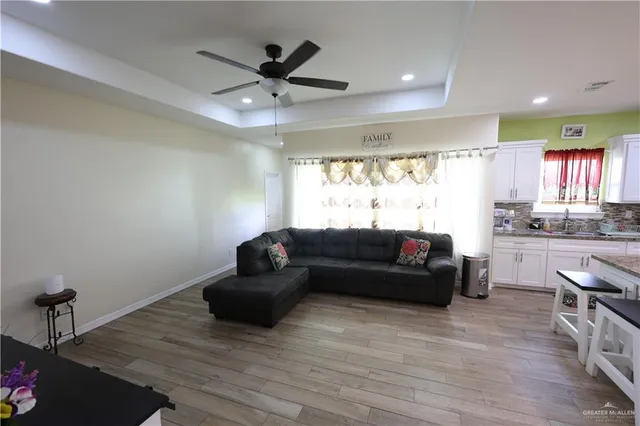 a living room with furniture and a wooden floor