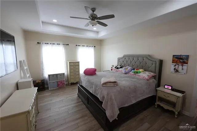 a bedroom with a bed a couch and a window