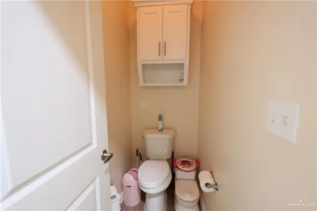 a white toilet sitting next to a small bathroom