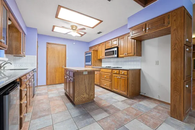 a kitchen with a cabinets and window