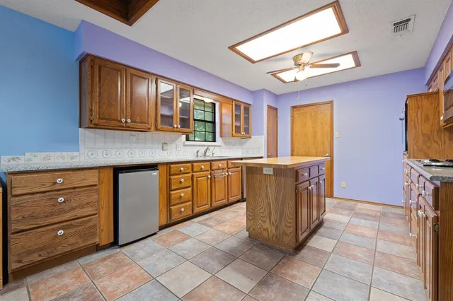 a kitchen with stainless steel appliances granite countertop a sink and cabinets