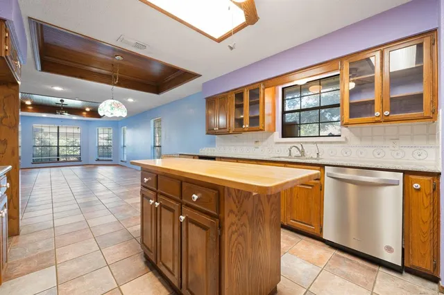 a kitchen with stainless steel appliances granite countertop a stove and a microwave