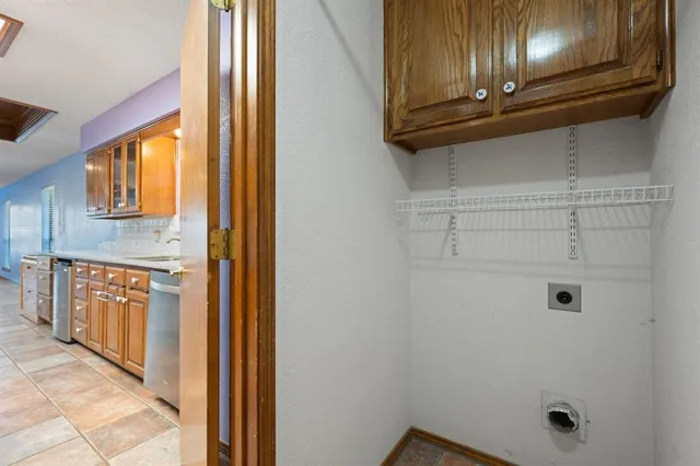 a kitchen with stainless steel appliances granite countertop a stove a washer and dryer