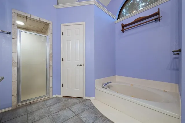 a bathroom with a bathtub and shower