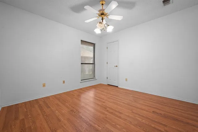 a bathroom with a granite countertop toilet sink and mirror