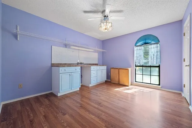 a kitchen with a sink cabinets and wooden floor