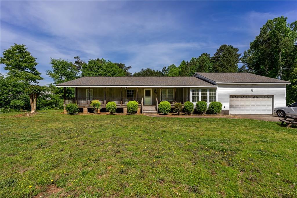 4925 Burruss Mill Road Cumming, GA 30041 - Photo 1 of 1 a front view of a house with garden