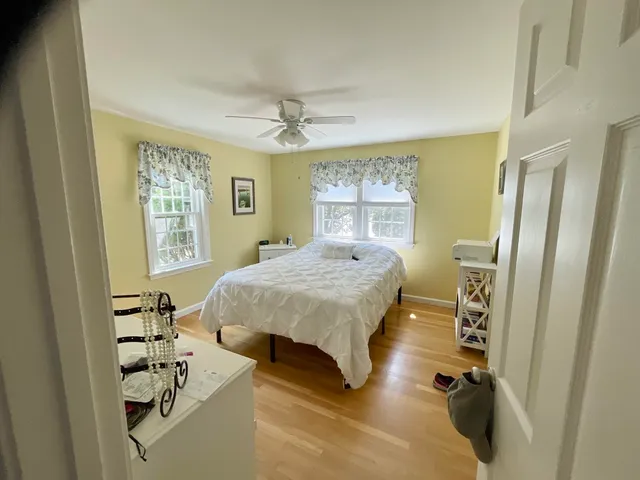 a spacious bedroom with a bed and a window