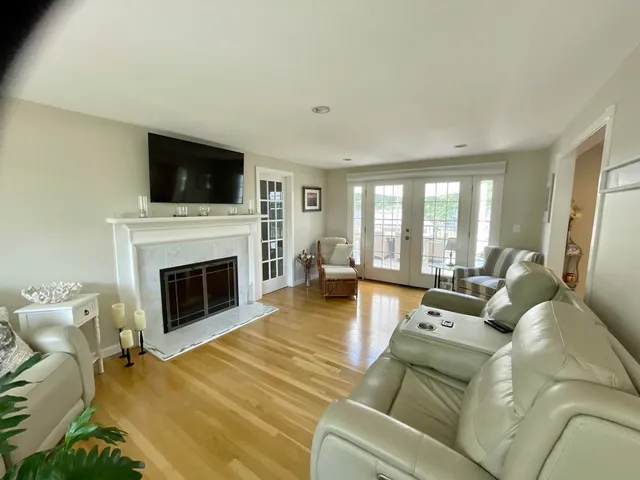 a living room with furniture a fireplace and a flat screen tv