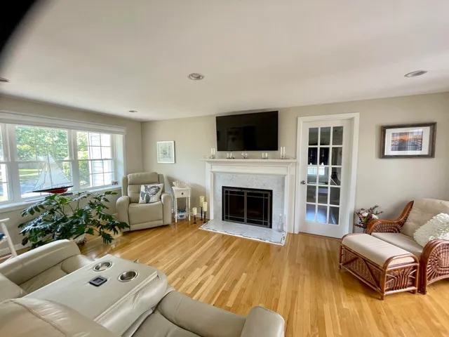 a living room with furniture fireplace and flat screen tv