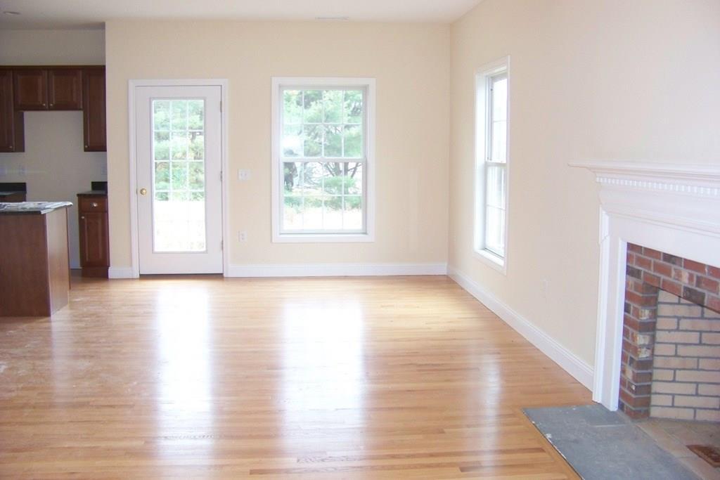 509 Main Street, Unit 4 Old Saybrook, CT 06475 - Photo 13 of 27 a view of a livingroom with wooden floor and a window