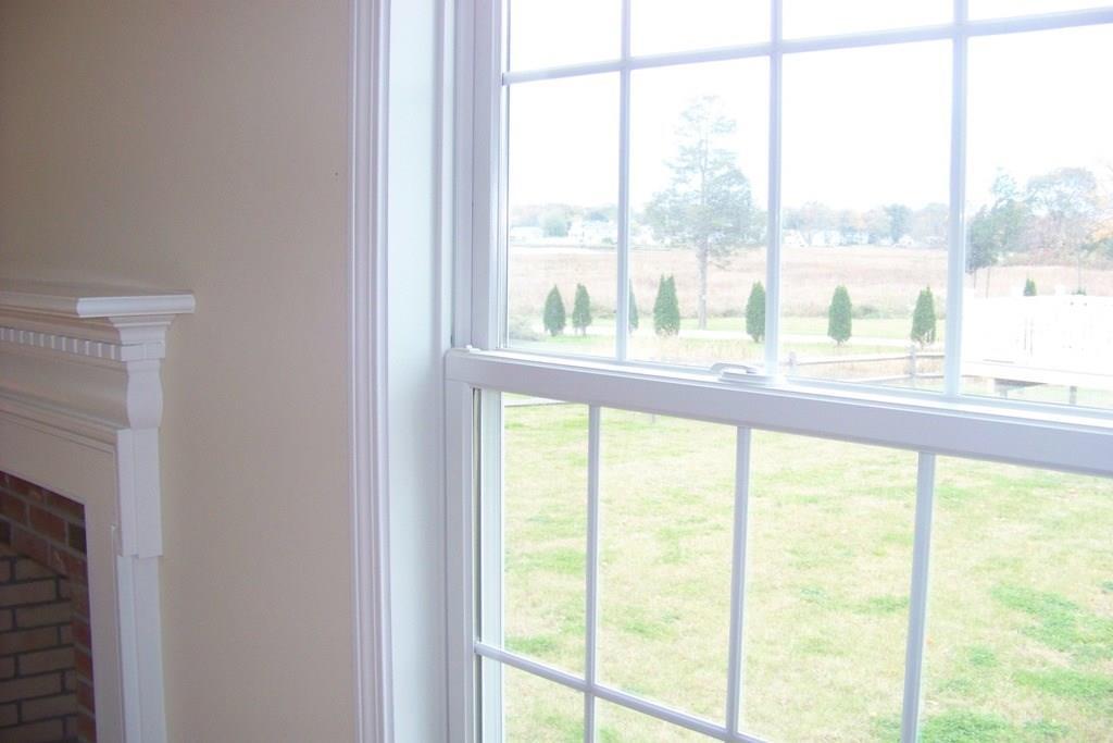 509 Main Street, Unit 4 Old Saybrook, CT 06475 - Photo 14 of 27 a view of an empty room with wooden floor and a window