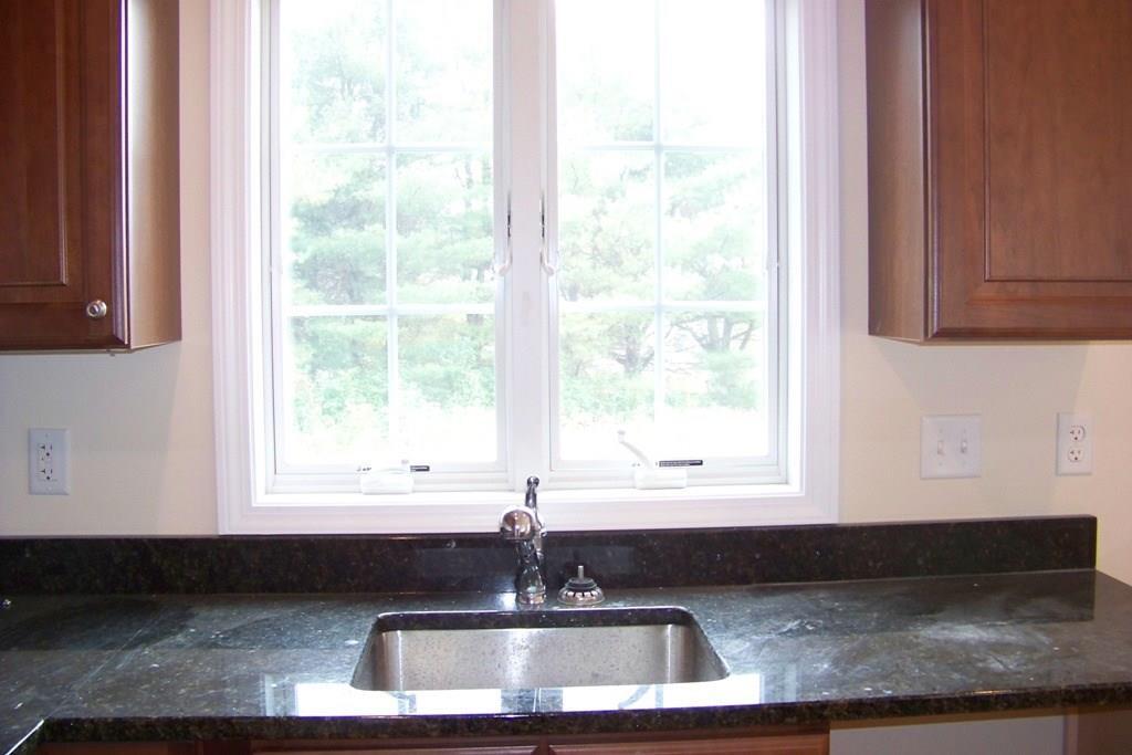 509 Main Street, Unit 4 Old Saybrook, CT 06475 - Photo 7 of 27 a kitchen with granite countertop a sink and a window
