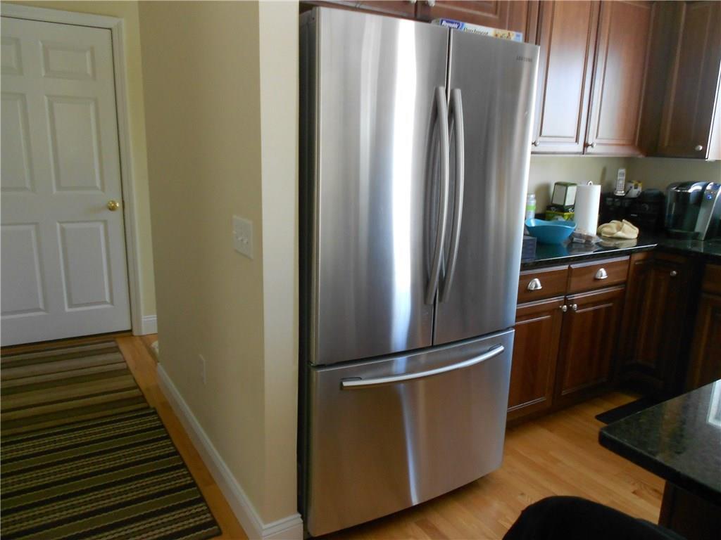 509 Main Street, Unit 4 Old Saybrook, CT 06475 - Photo 8 of 27 a kitchen with stainless steel appliances granite countertop a refrigerator and a sink