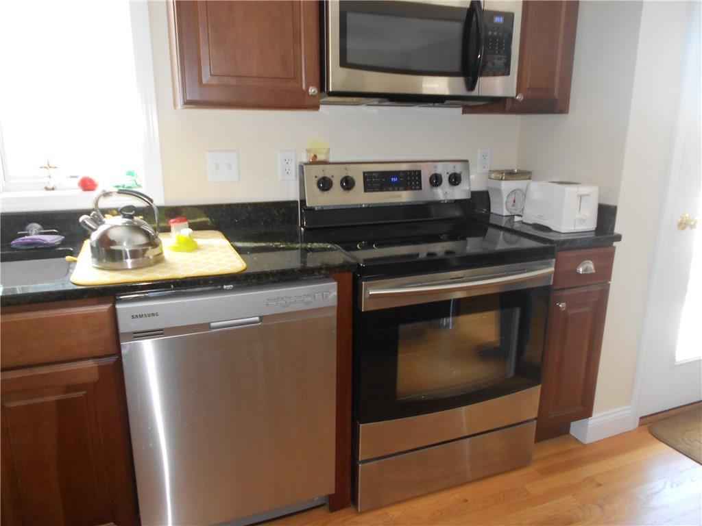 509 Main Street, Unit 4 Old Saybrook, CT 06475 - Photo 9 of 27 a kitchen with appliances a sink and a stove