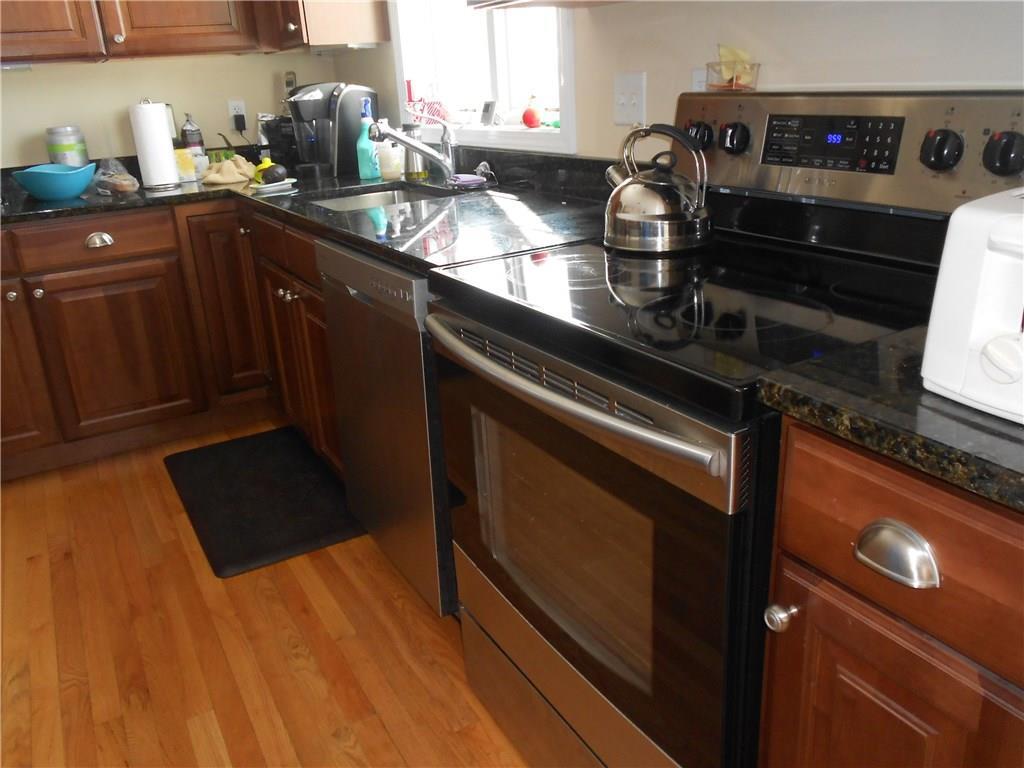509 Main Street, Unit 4 Old Saybrook, CT 06475 - Photo 10 of 27 a kitchen with granite countertop a stove and a sink
